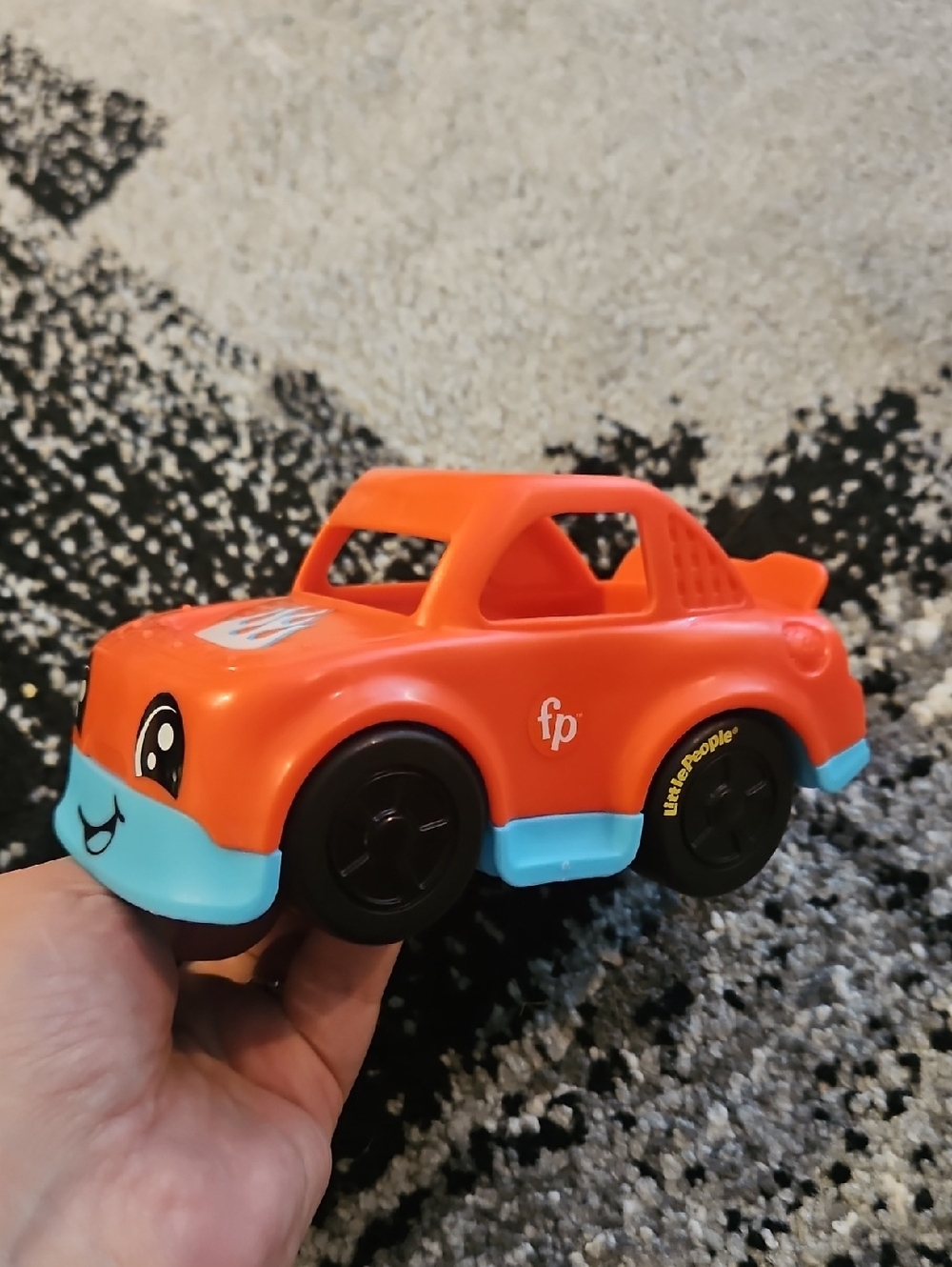 Fisher-Price Little People orange and blue toy car.